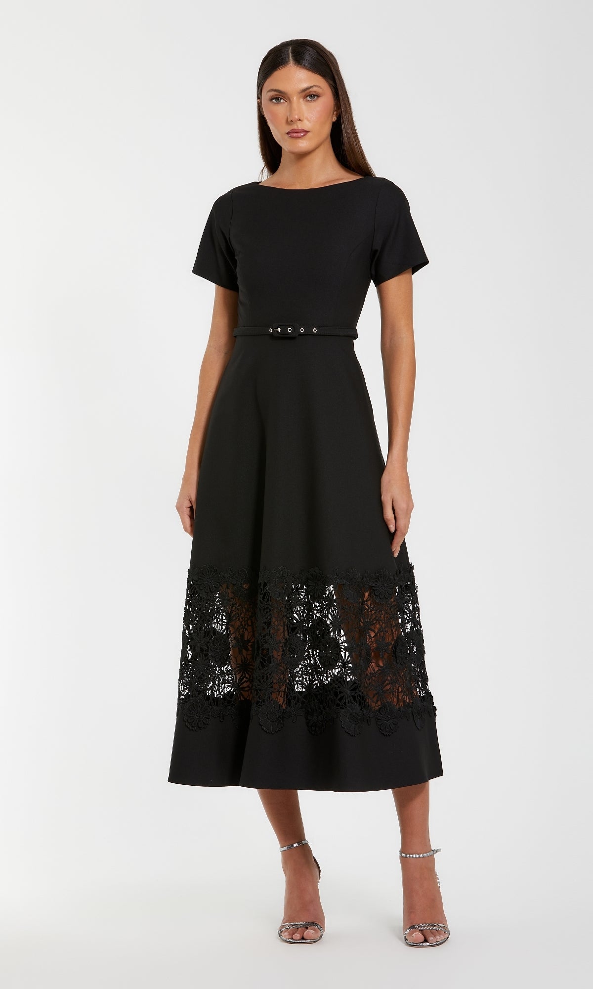Model in the Mac Duggal 81206 Short Sleeve Midi Cocktail Dress, featuring a belted waist and lace hem panel, poses against a plain white background.